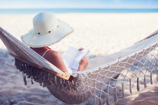 Young,Lady,Reading,A,Book,In,Hammock,On,Tropical,Sandy